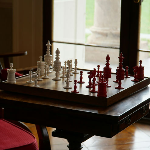 white and red chess set on a table