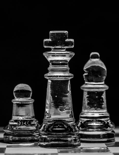 Three transparrent chess pieces.